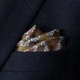 Tile design silk pocket square in brown, green and turquoise by Otway & Orford folded in top pocket of jacket.