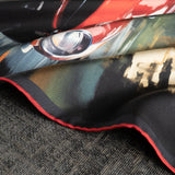 Close up of a 1960s sports car design silk pocket square in red and grey by Otway & Orford with gentle folds.