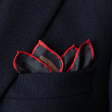 1960s sports car design silk pocket square in red and grey by Otway & Orford folded in top pocket of jacket with points showing.