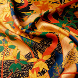 Close up of gently folded exotic silk pocket square in gold, orange, green and blue using 1920s painting 'The Hunt' by Robert Burns which features Roman goddess Diana and her nymphs hunting.