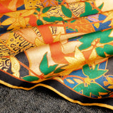 Close up of gently folded exotic silk pocket square in gold, orange, green and blue using 1920s painting 'The Hunt' by Robert Burns which features Roman goddess Diana and her nymphs hunting.