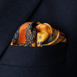Exotic silk pocket square in gold, orange, green and blue using 1920s painting 'The Hunt' by Robert Burns which features Roman goddess Diana and her nymphs hunting. Here folded in top pocket of jacket.