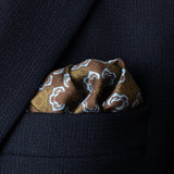Tile design silk pocket square in brown, green and turquoise by Otway & Orford folded in top pocket of jacket.