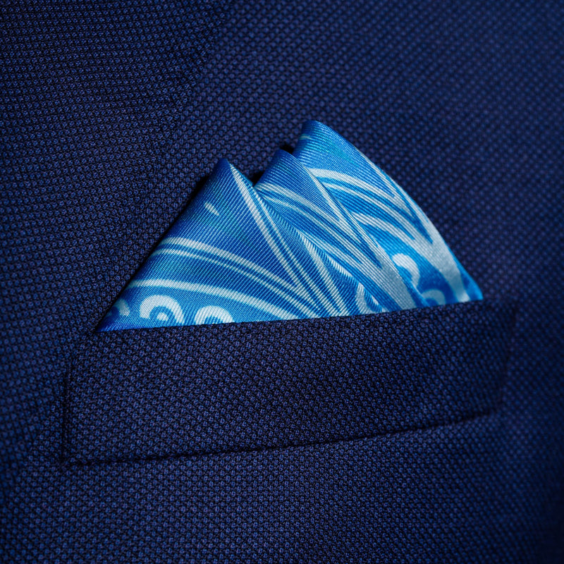 Paisley pattern silk pocket square in turquoise with blue & green by Otway & Orford folded in top pocket
