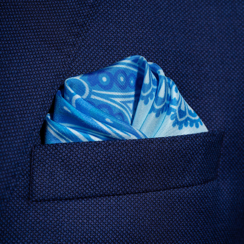 Paisley pattern silk pocket square in turquoise with blue & green by Otway & Orford folded in top pocket