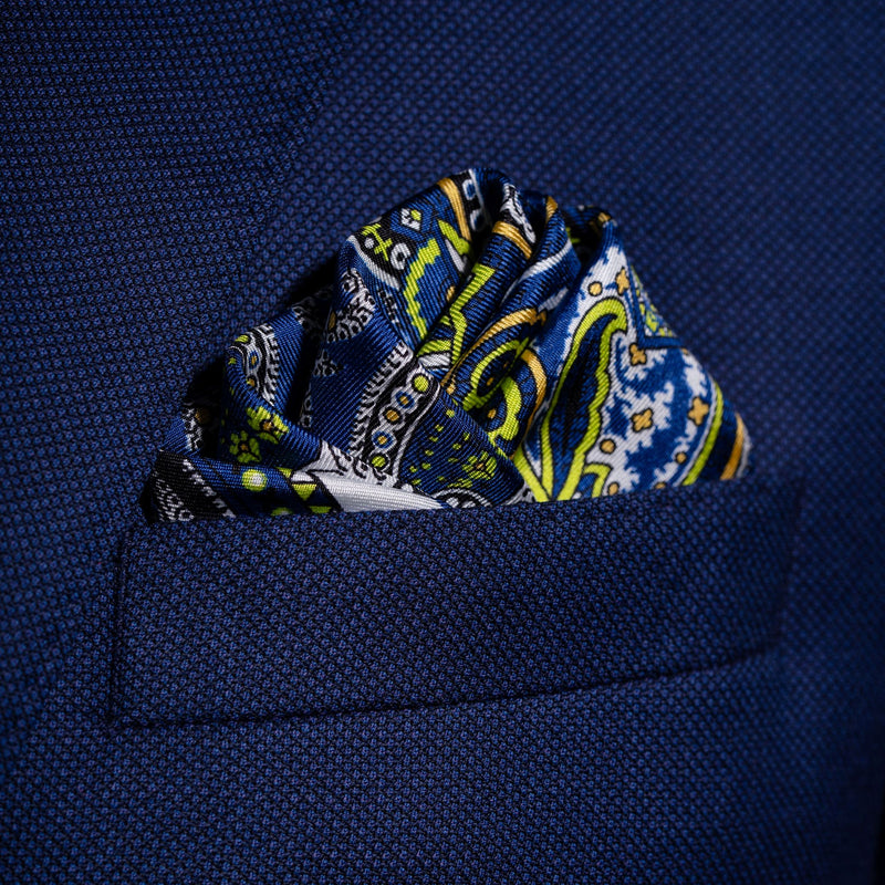 Labyrinth paisley silk pocket square in blue and white with lime green and orange by Otway & Orford folded in top pocket