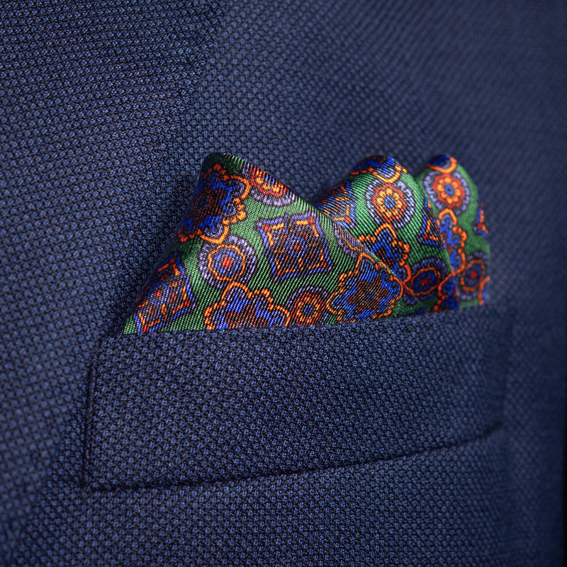 Millefiori silk pocket square in green, blue & orange by Otway & Orford folded in top pocket
