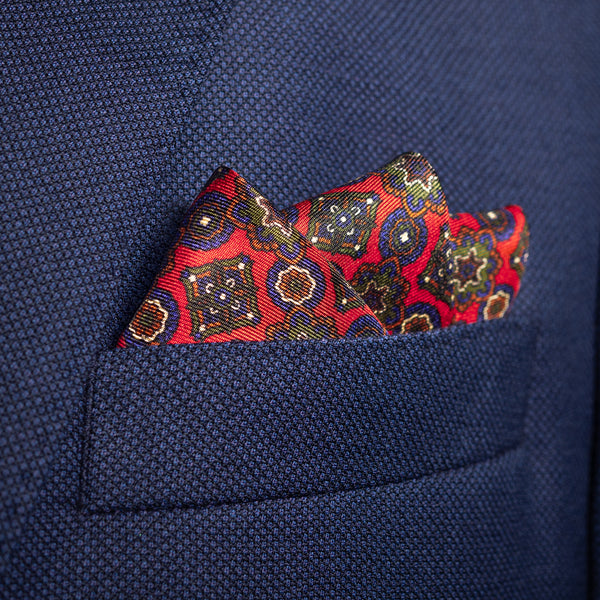 Millefiori silk pocket square in red, blue, green & white by Otway & Orford folded in top pocket