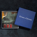 Silk pocket square featuring iconic US muscle car in Highland Green on orange background folded neatly in Otway & Orford branded blue gift box.