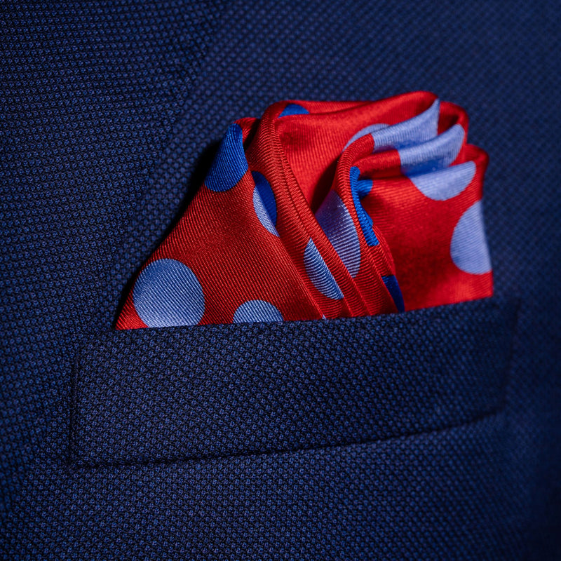 'Planetarium' polka dot silk pocket square in red with blue dots by Otway & Orford folded in top pocket