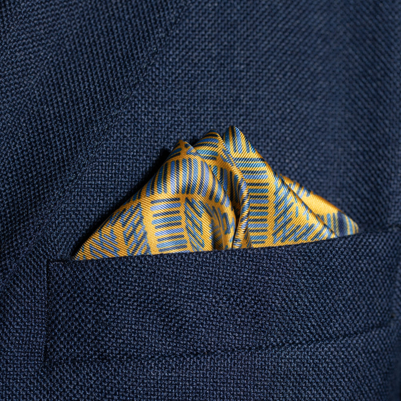 Squares design silk pocket square in gold & blue by Otway & Orford folded in top pocket