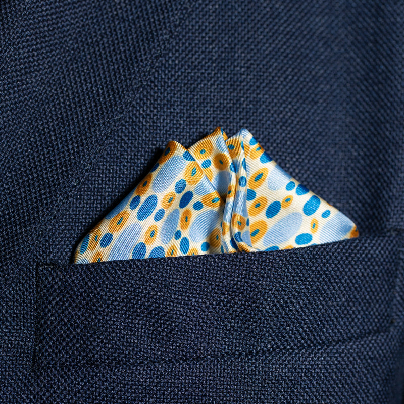 Spots design silk pocket square in blue, gold & white by Otway & Orford folded in top pocket