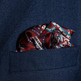 Intricate paisley design silk pocket square in burgundy, red, blue & cream by Otway & Orford folded in top pocket
