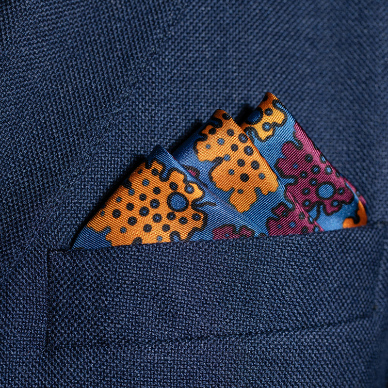 Leaf design silk pocket square in blue, burgundy & gold by Otway & Orford folded in top pocket