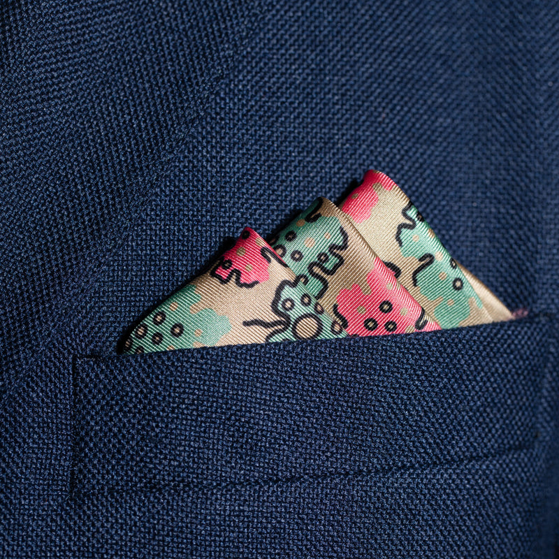 Leaf design silk pocket square in camel, green & pink by Otway & Orford folded in top pocket